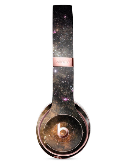 Galaxy-themed wireless headphones with a rose gold accent and cosmic star patterns.