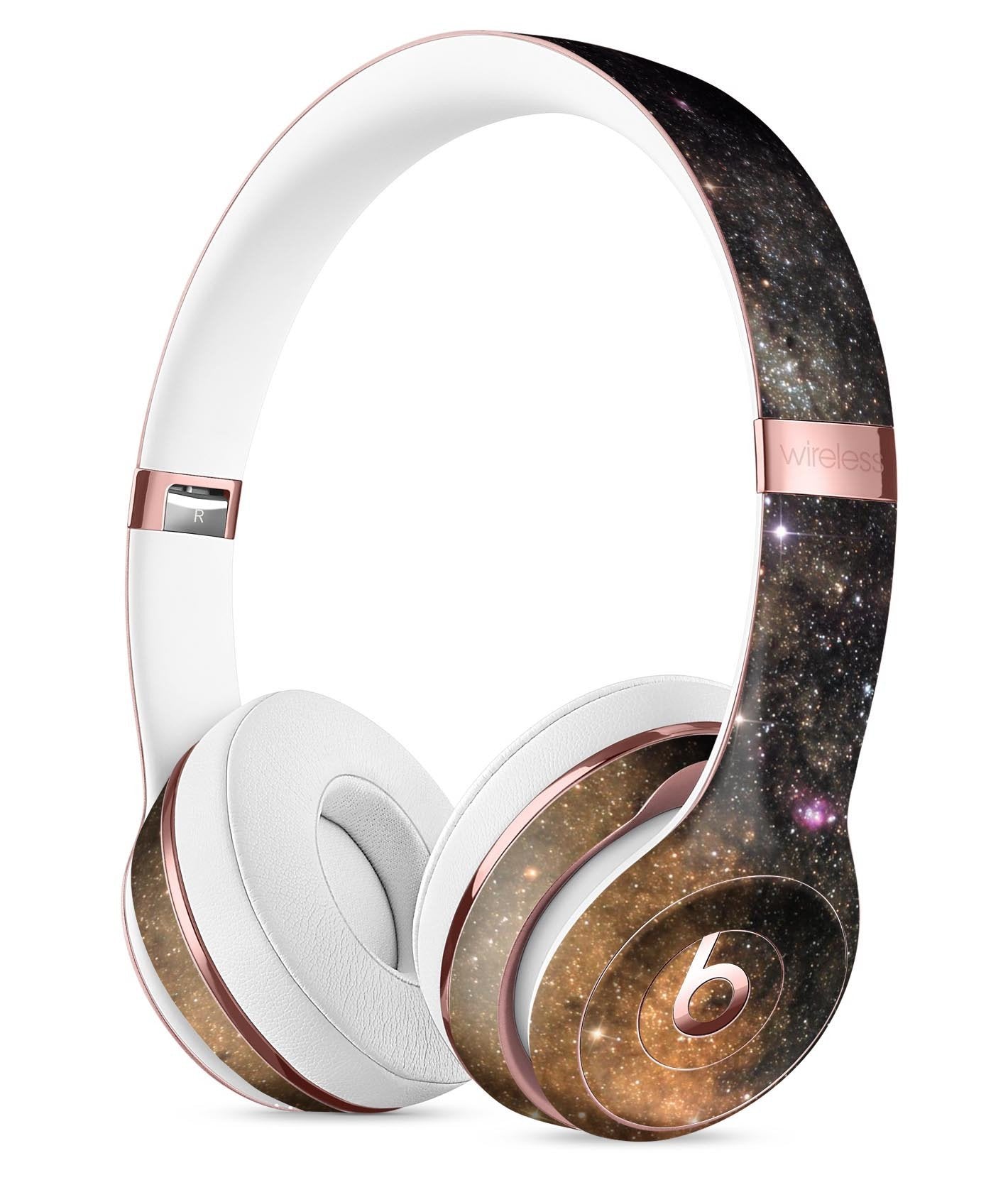 Stylish headphones with a galaxy pattern, white ear cushions, and rose gold accents.