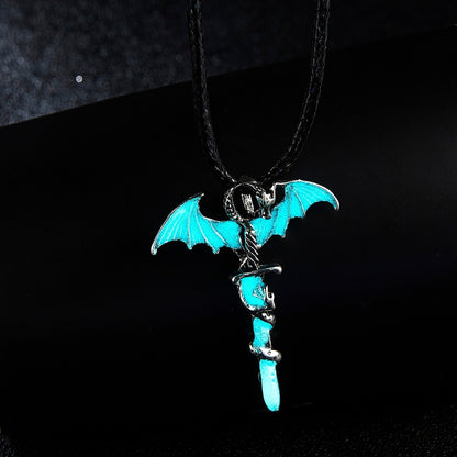 Pendant with blue dragon wings and snake wrapped around a sword, on a black background.