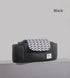 Black bag with white chevron-patterned flap on a gray surface, labeled "love."