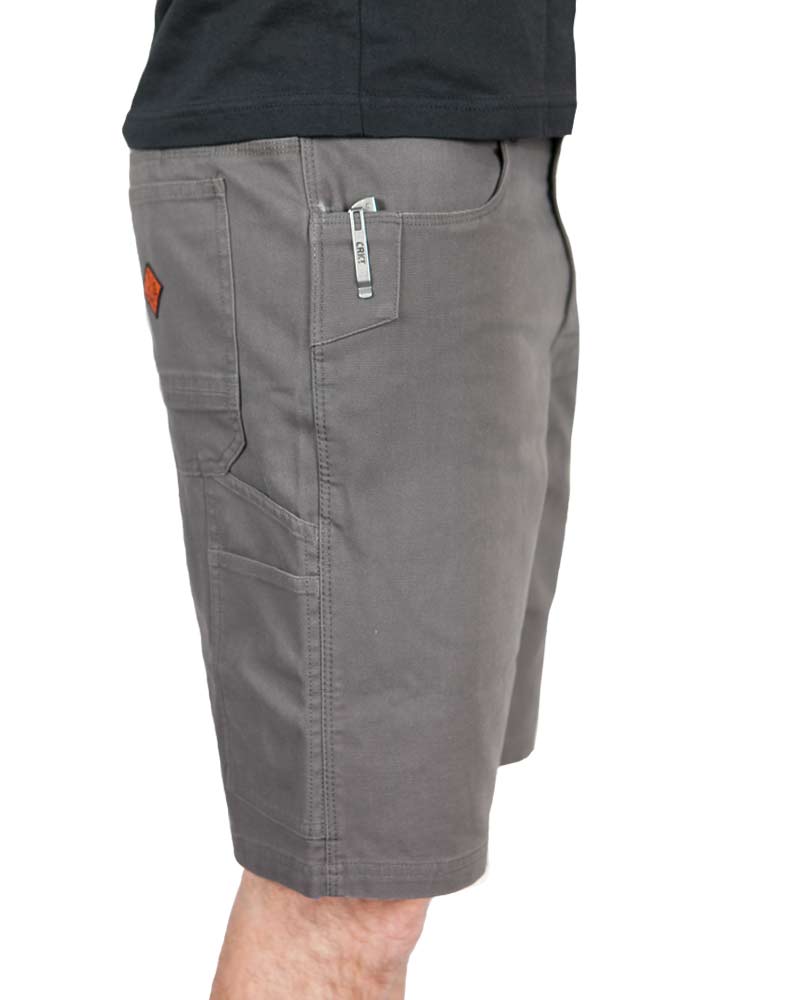 Person in gray cargo shorts with side pockets and a logo, wearing a black shirt.