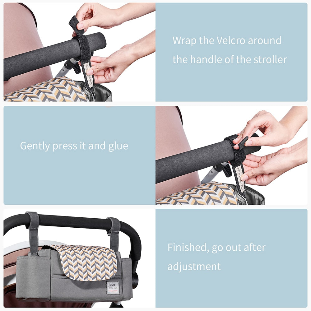Hands attaching a geometric-patterned stroller organizer with Velcro to a black handle.