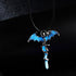 Pendant with blue bat wings and a glowing blue dagger, detailed on a dark background.