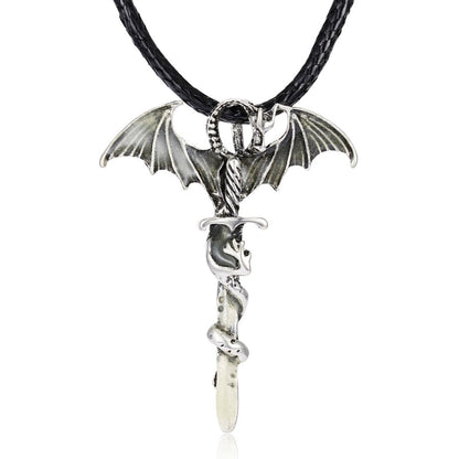Silver necklace with bat wings and a snake design on a black braided cord.