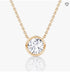 Gold chain necklace with a large round diamond pendant in a sleek bezel setting, on a white background.