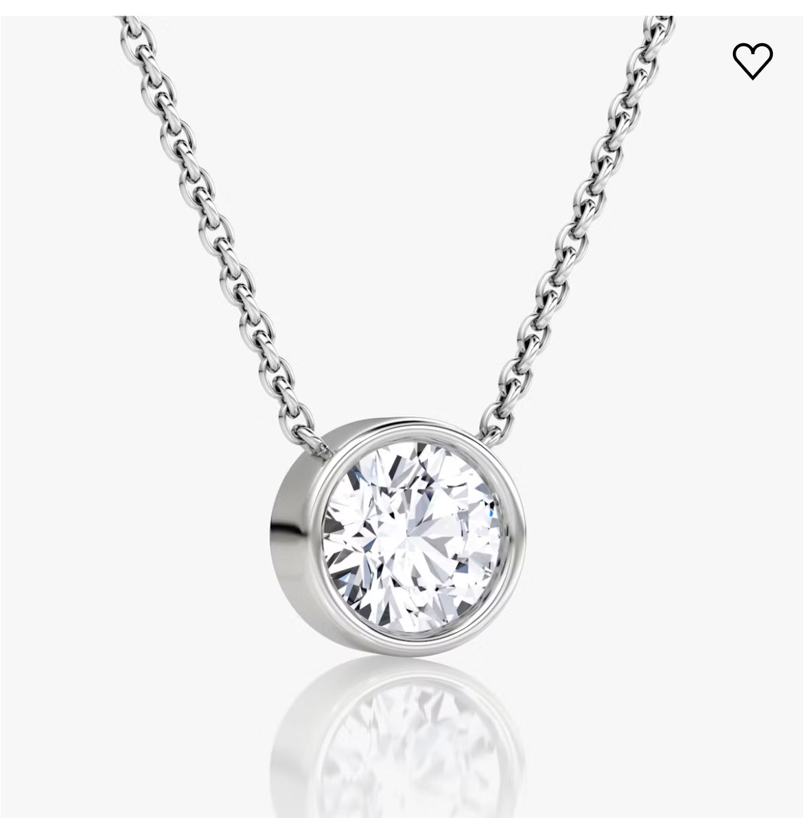 Silver chain with a round diamond pendant in a bezel setting on a white background.