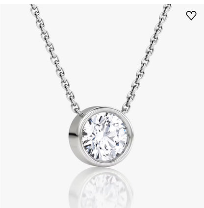 Silver chain with a round diamond pendant in a bezel setting on a white background.