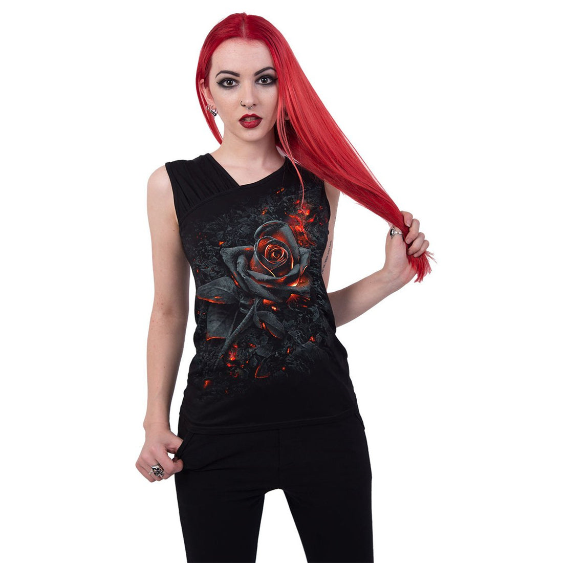 Red-haired person in a black top with a fiery rose design, holding hair to the side.