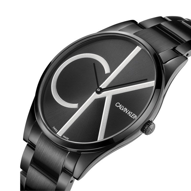 Sleek black watch with large silver letters "CK" on the dial and a stainless steel bracelet.