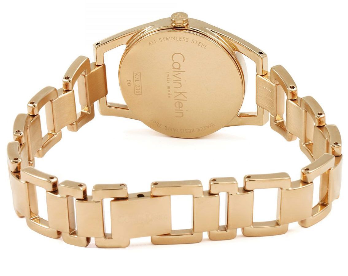 Gold stainless steel watch with rectangular links and a round case back featuring engraved text.