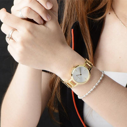 A gold wristwatch on a woman&