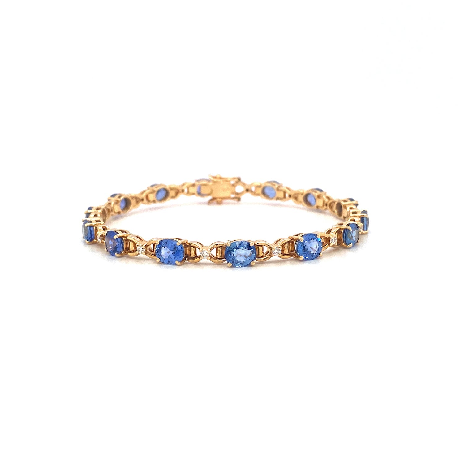 Gold bracelet with blue gemstone links, arranged in a circular pattern on a white background.