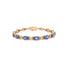 Gold bracelet with blue gemstone links, arranged in a circular pattern on a white background.