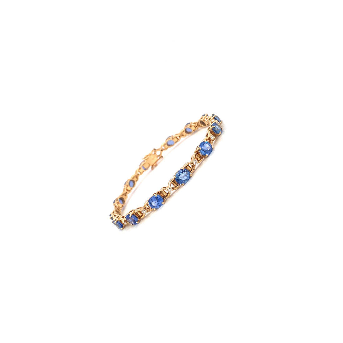 Gold bracelet with blue gemstones in a linked pattern on a white background.