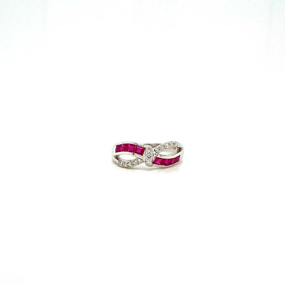 Silver infinity ring with red stones and clear crystals on a white background.