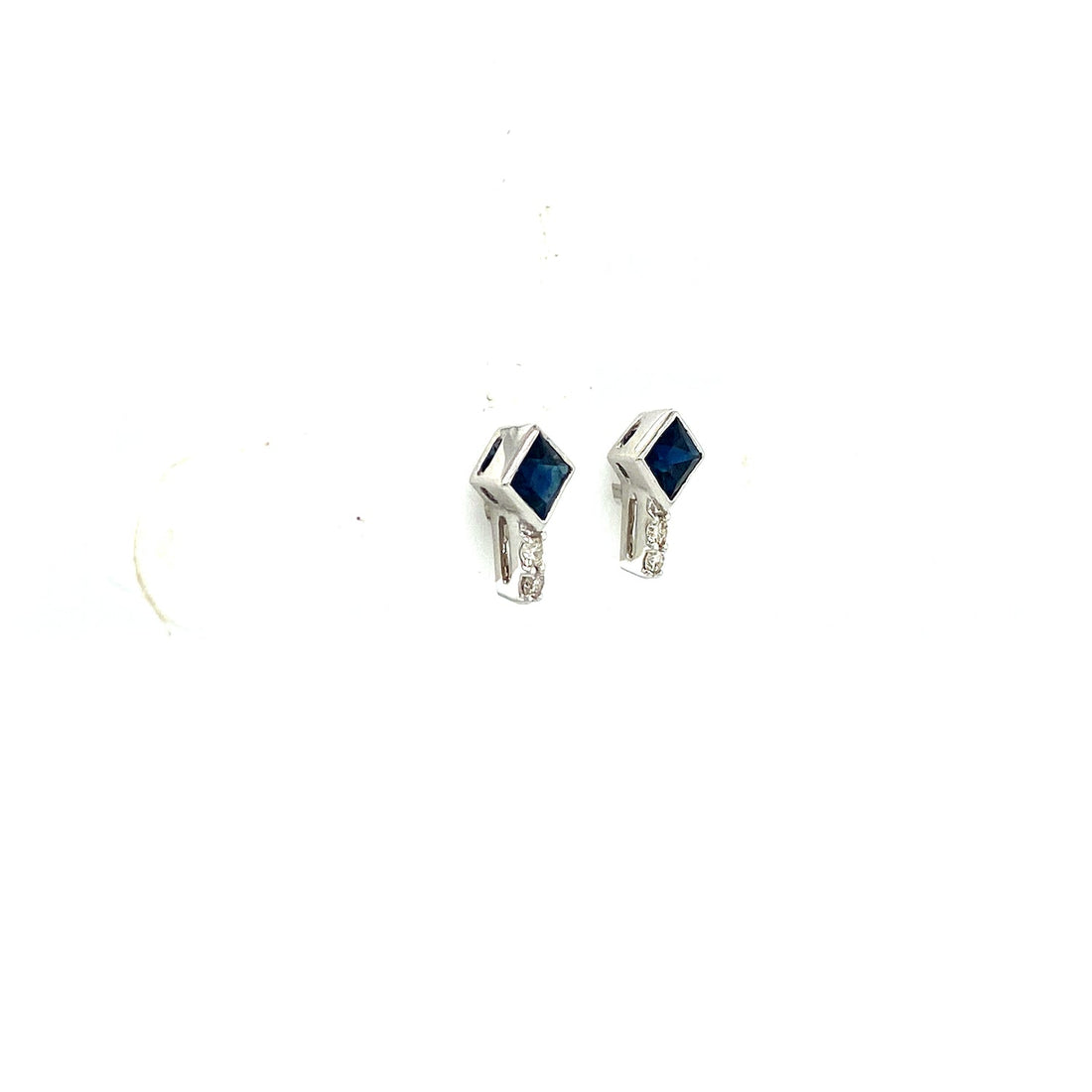 Silver and blue gem earrings with diamond accents, set against a plain white background.