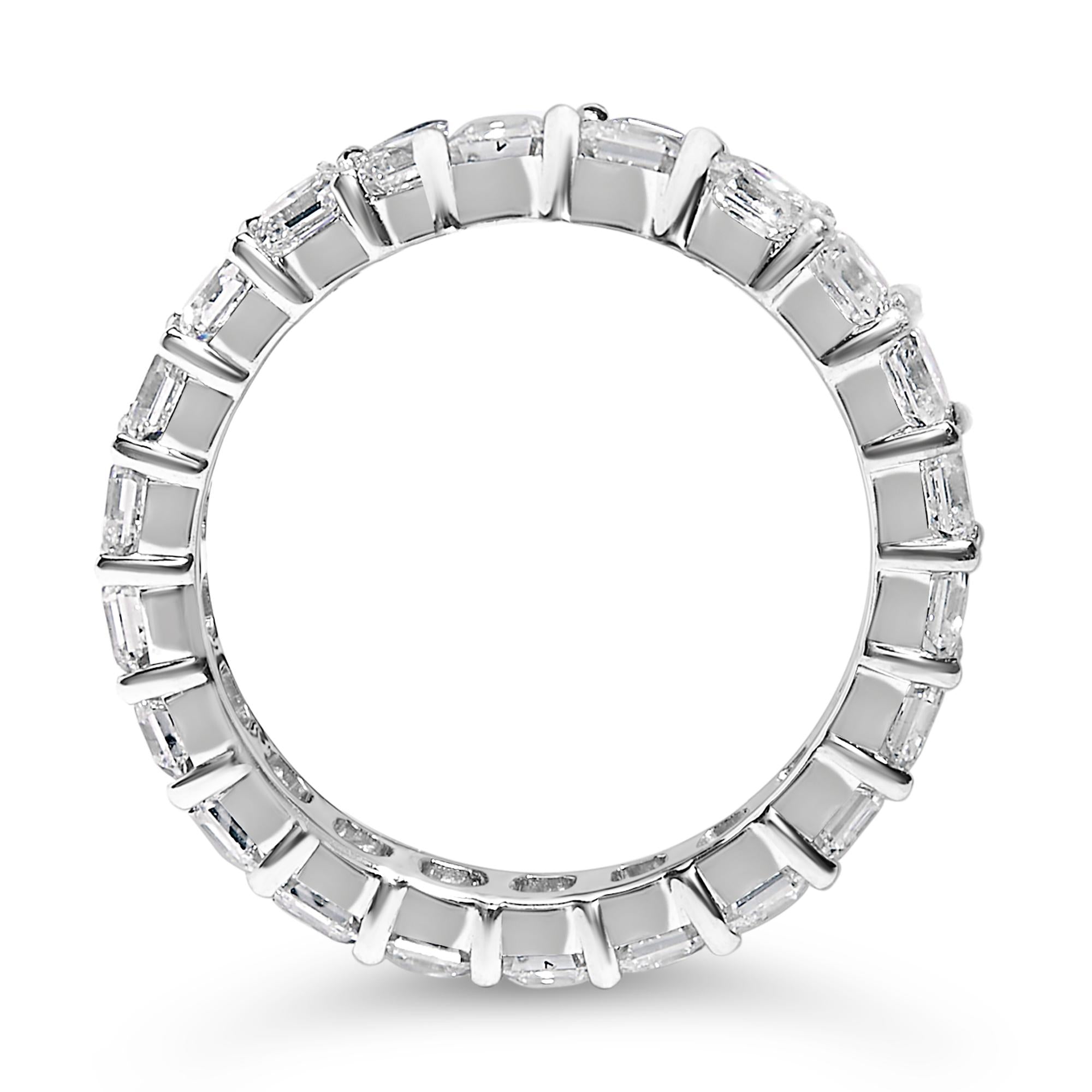 Silver ring with rectangular diamonds set all around, shown on a white background.