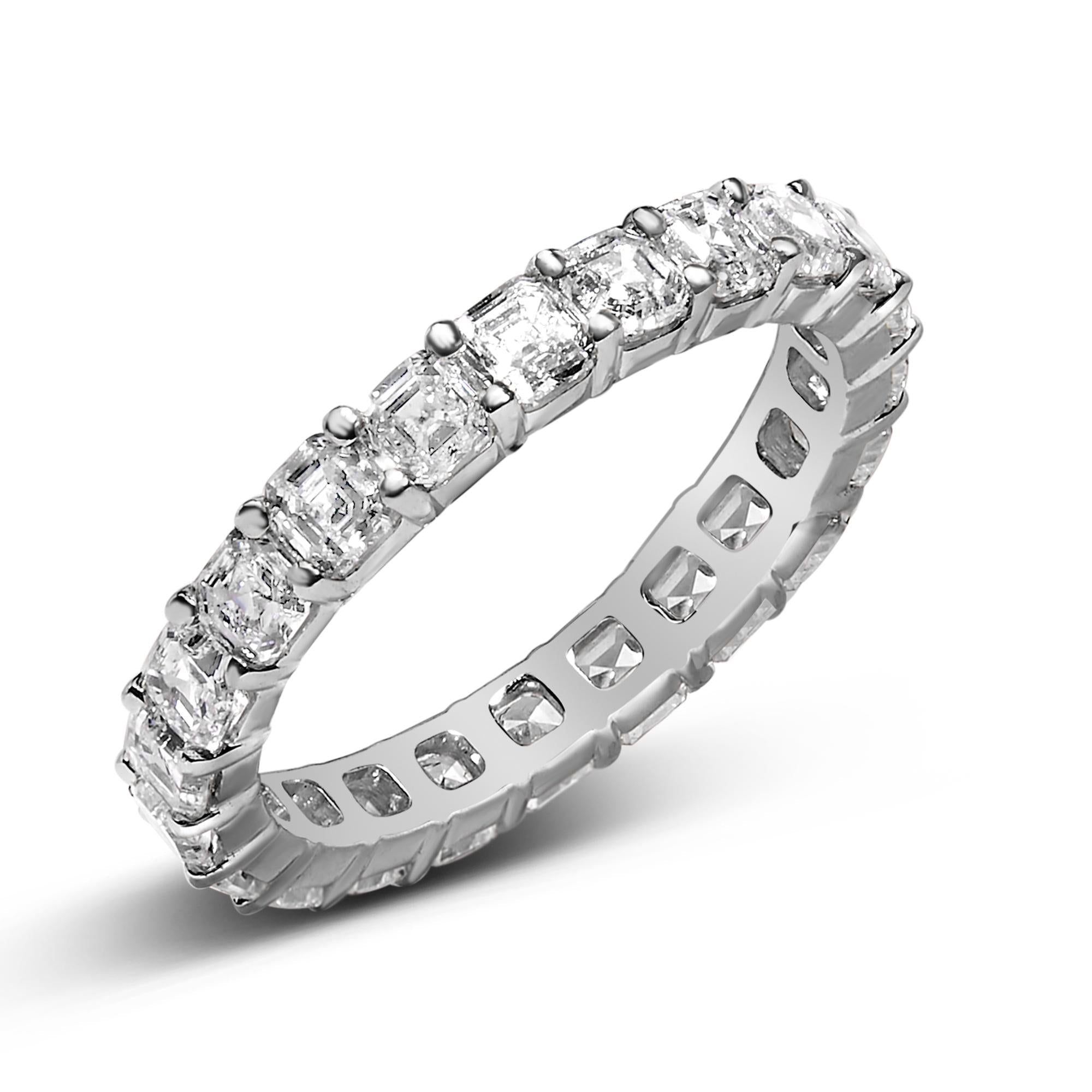 Silver ring with square-cut diamonds, arranged in a continuous band, reflecting light.