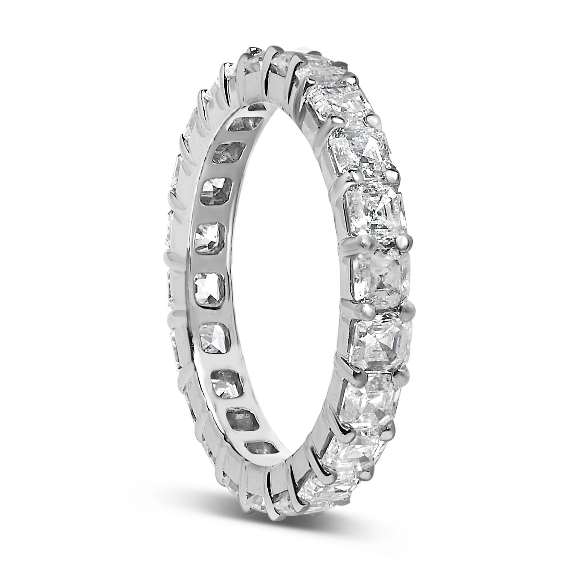 Silver eternity ring with square-cut clear stones, held by prongs, forming a continuous loop.