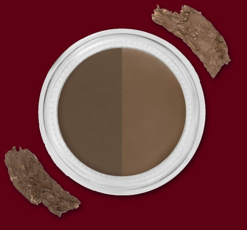 A round makeup pot divided into two brown shades on a red background with brown smudges.