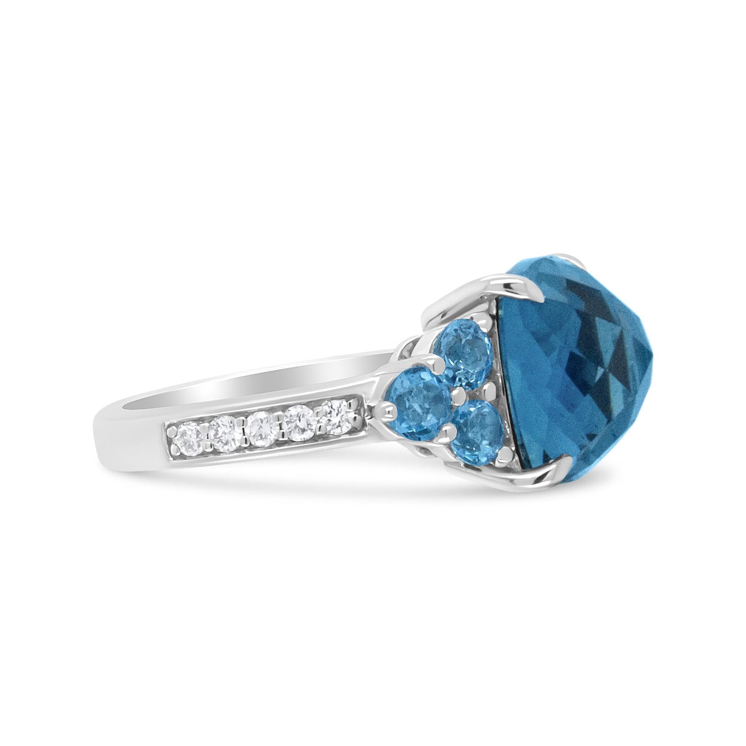 Silver ring with a large blue gemstone, three smaller blue stones, and a row of clear stones.