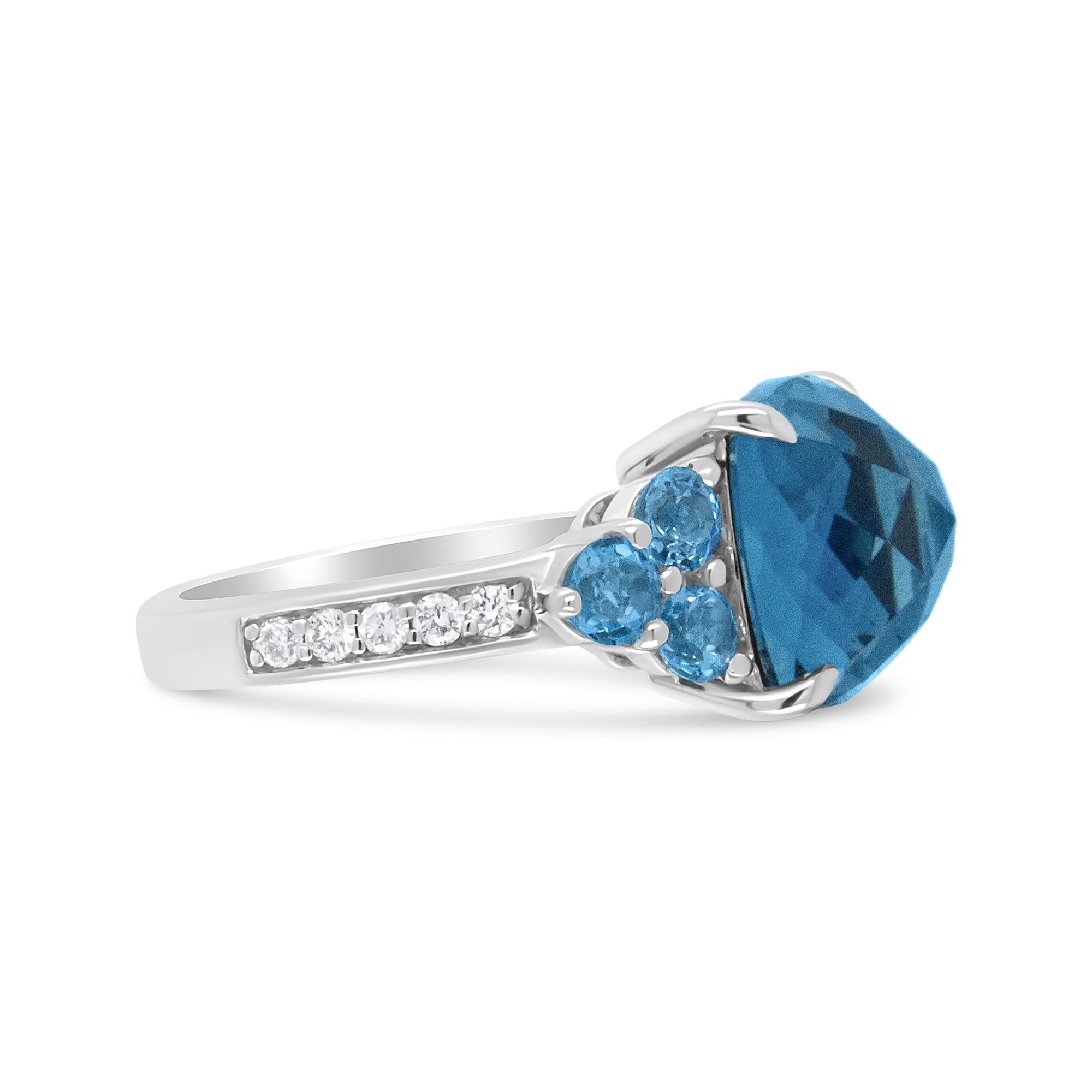 Silver ring with a large blue gemstone, three smaller blue stones, and a row of clear stones.