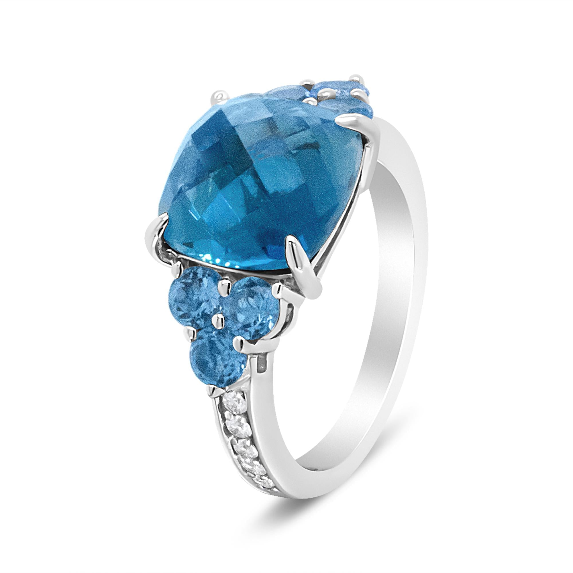 Silver ring with large blue faceted stone, three round blue stones, and small clear stones.