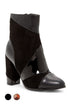 Black ankle boot with glossy and matte sections, block heel, and pointed toe.