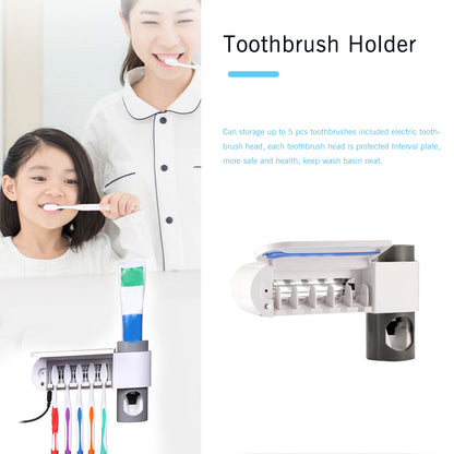 Woman and child brushing teeth beside a wall-mounted toothbrush holder with colorful brushes.