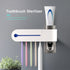 Wall-mounted toothbrush sterilizer with five colorful toothbrushes and a toothpaste dispenser.