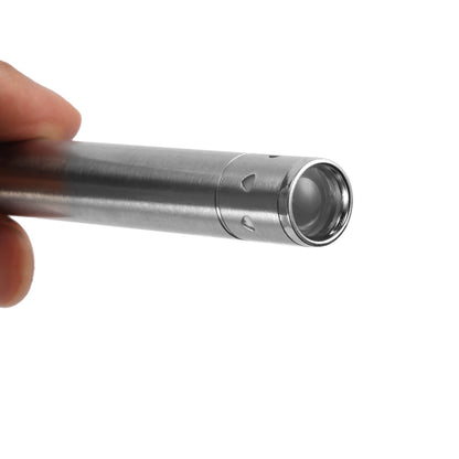 A hand holding a silver metallic penlight with a smooth cylindrical design and a clear lens.