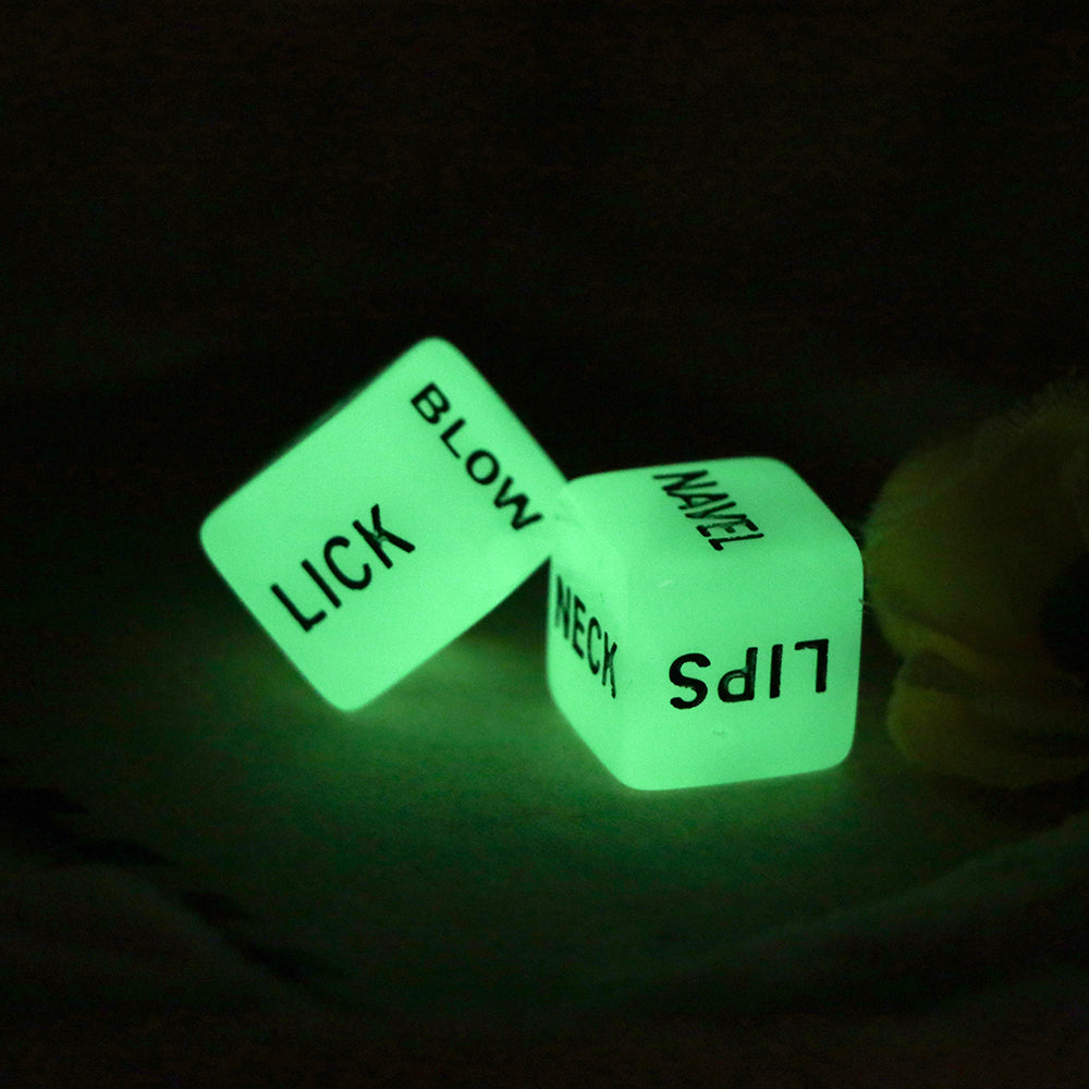 Two glowing green dice in the dark showing words like "LICK" and "NECK."