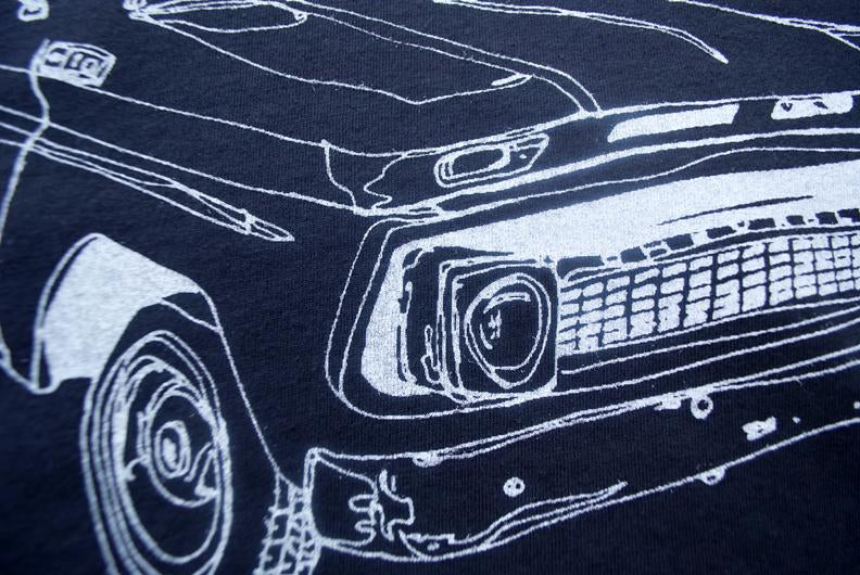 White line drawing of a classic truck front on a dark fabric background.