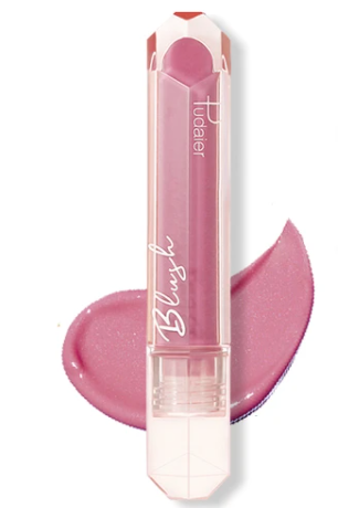 Pink lipstick tube with a transparent cap, placed on a pink lipstick smear.