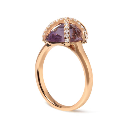 Gold ring with a purple gemstone and diamond accents on a smooth, reflective band.