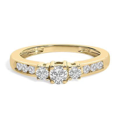 Gold ring with three larger diamonds in the center and smaller diamonds on the band.