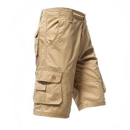 Beige cargo shorts with multiple pockets and button closure on a white background.