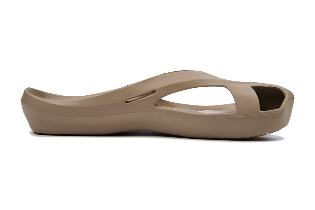Taupe sandal with open toe, cut-out sides, and a smooth, slightly curved sole.