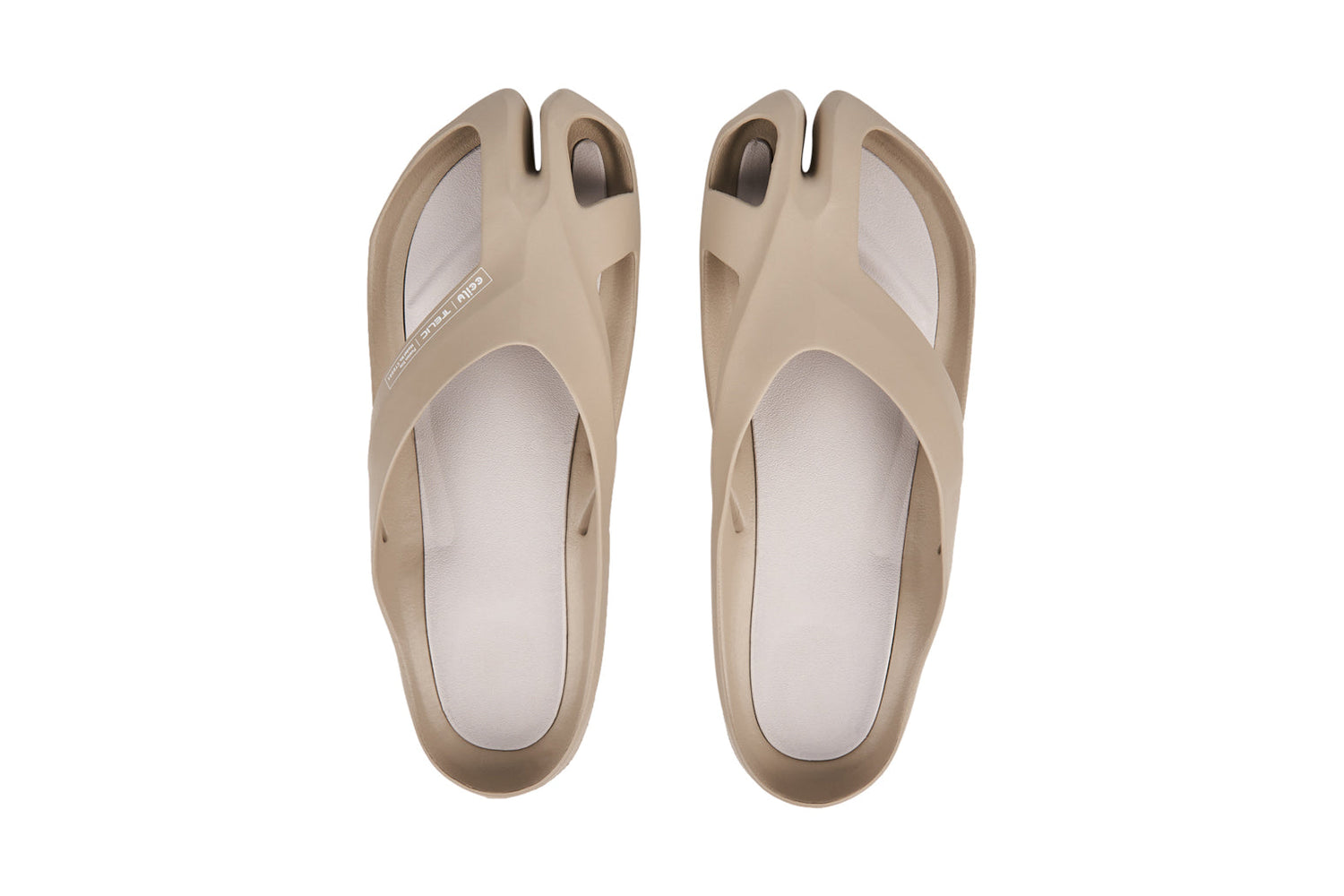Beige open-toe sandals with a split-toe design and sleek, minimalist look.