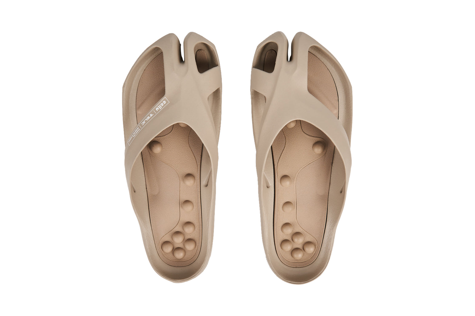 Beige split-toe sandals with textured footbed and wide straps, viewed from above.