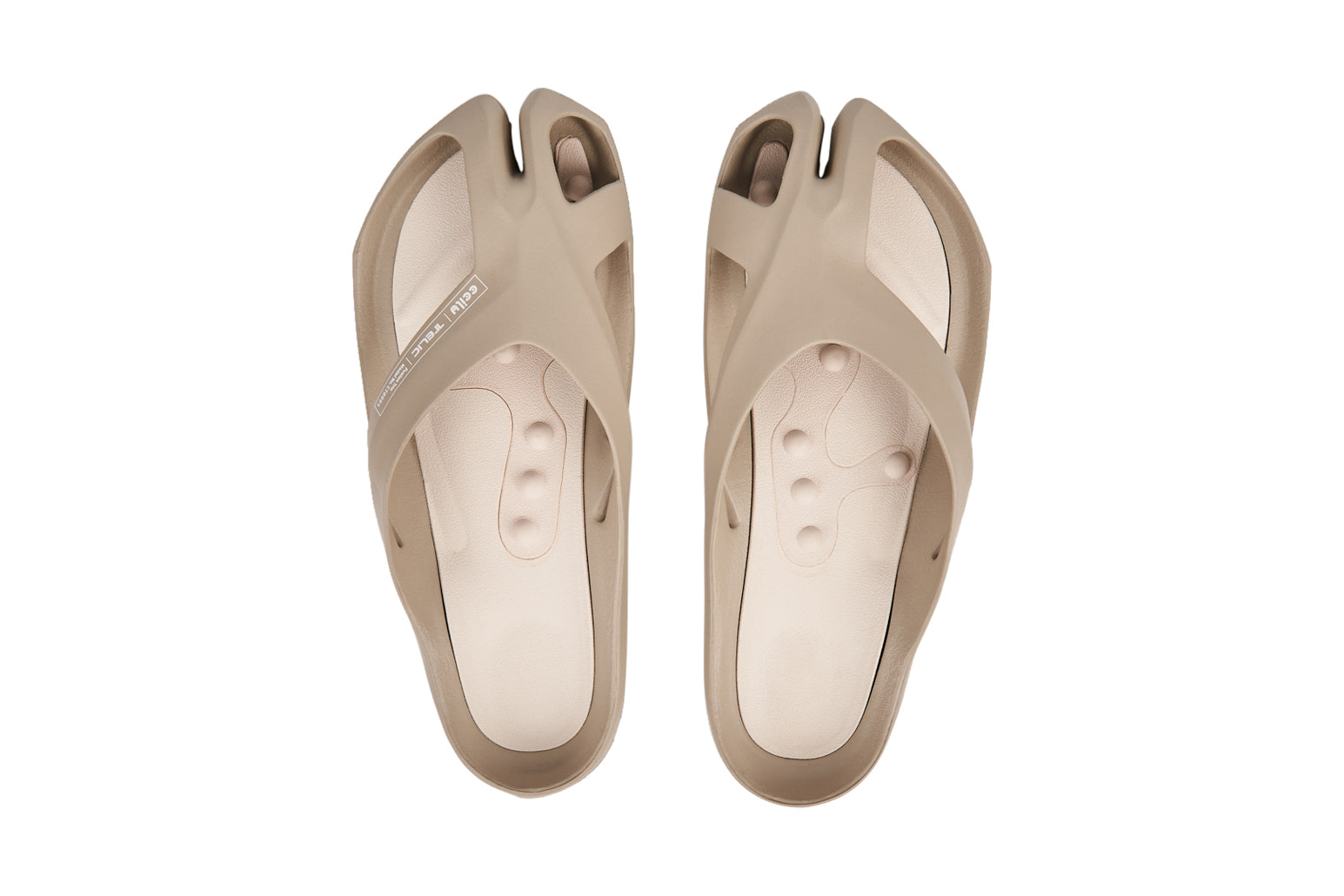 Beige split-toe sandals with crisscross straps and textured insoles.