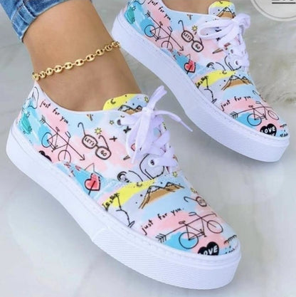 Colorful sneakers with bicycle and sunshine prints, white soles, and white laces.