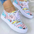 Colorful sneakers with bicycle and sunshine prints, white soles, and white laces.