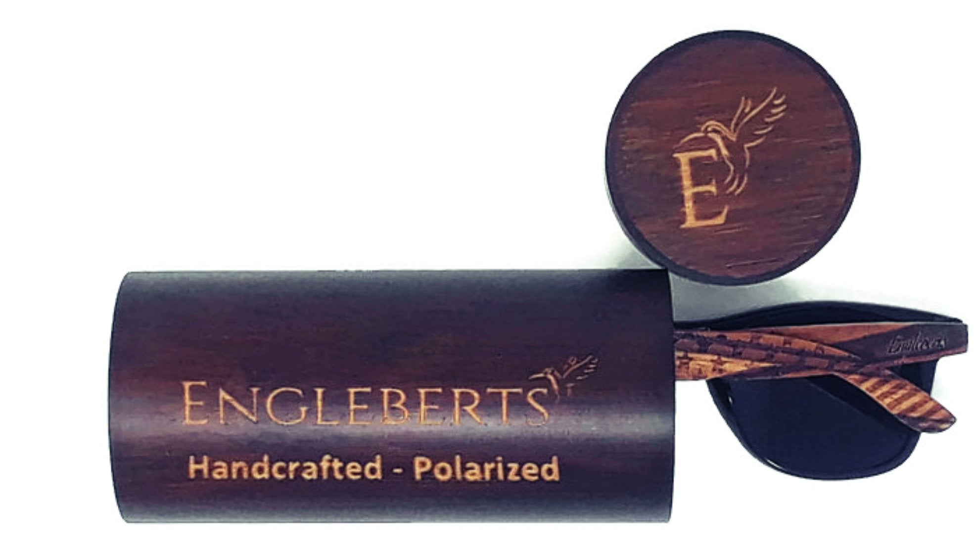 Dark wooden cylinder case with engraved text and a matching brown sunglasses arm visible.