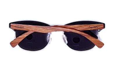Black sunglasses with brown wooden arms crossed, on a white background.