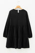 Black long-sleeve dress with tiered skirt on a wooden hanger against a white background.