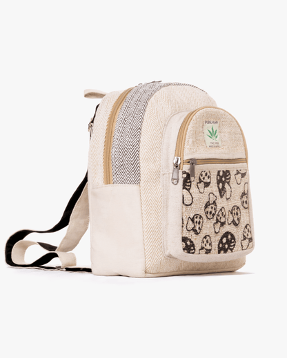 Beige backpack with black mushroom design, herringbone patterns, and a hemp label on the pocket.