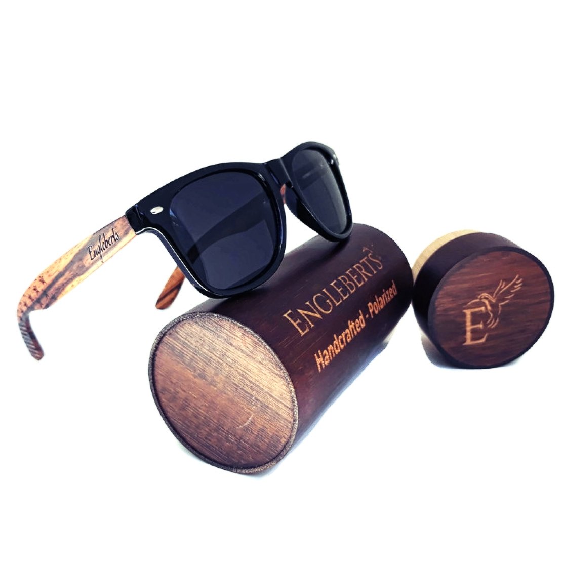 Black sunglasses with wooden arms on a cylindrical wooden case labeled "Englebert&