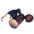 Black sunglasses with wooden arms on a cylindrical wooden case labeled "Englebert&