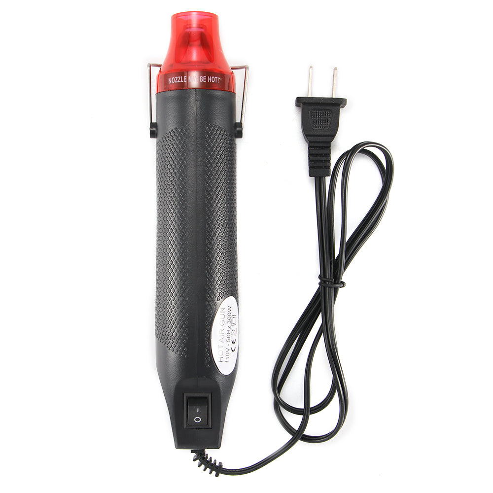 Black heat gun with a red nozzle, textured grip, power switch, and attached black power cord.